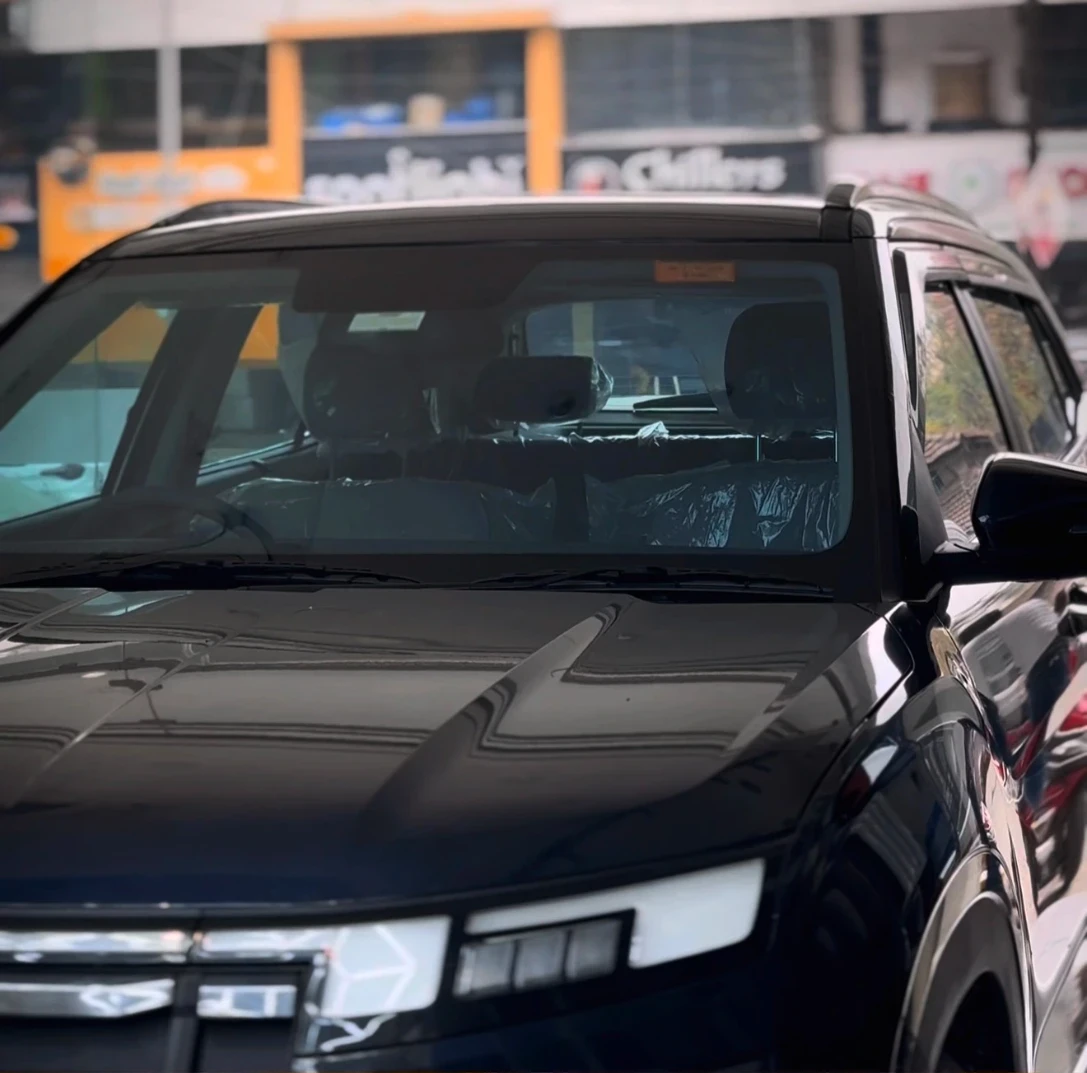 Black SUV after SunProtek window film fitting, front view