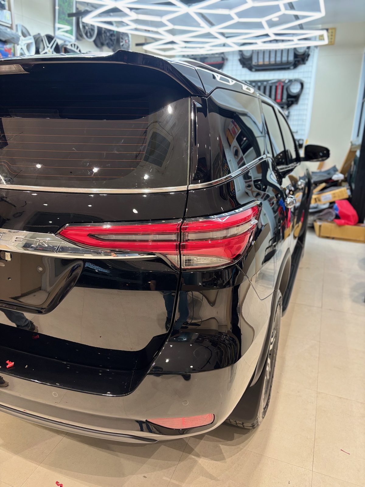 Rear of a black Fortuner with paint protection film